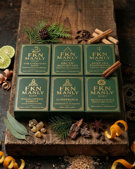 6 Bars Of FKN Manly Grass Fed Beef Tallow Soap For Men Laid On A Wooden Board With Natural Ingredients Surrounding.