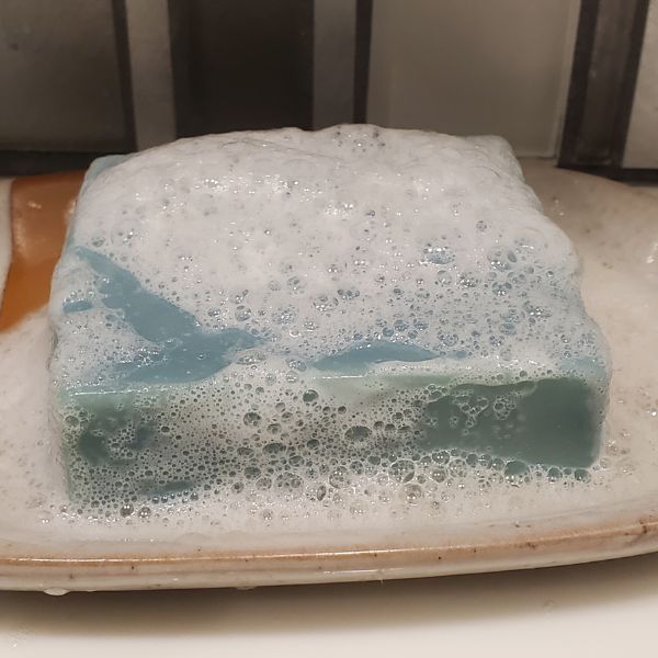 Fkn Manly Deep Sea Fisherman Soap In A Soap Dish Covered In Suds