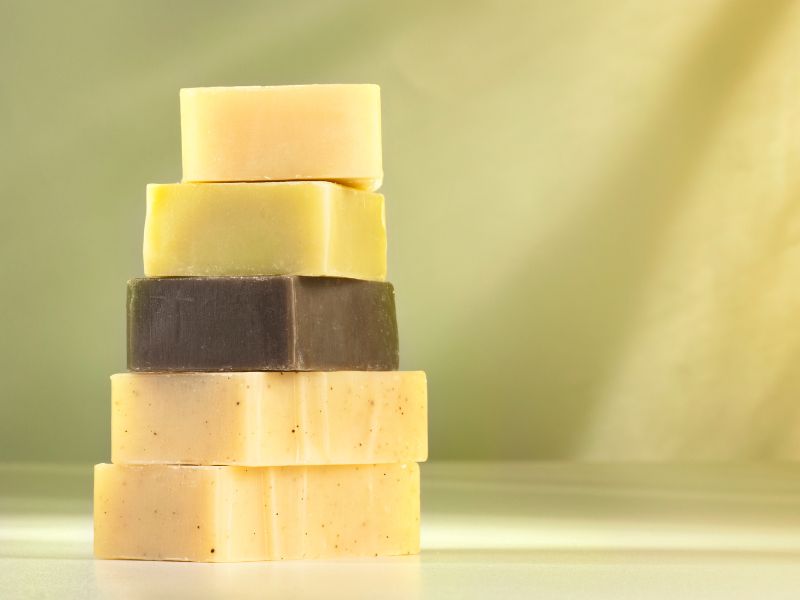 A pile of natural soap bars with a green background